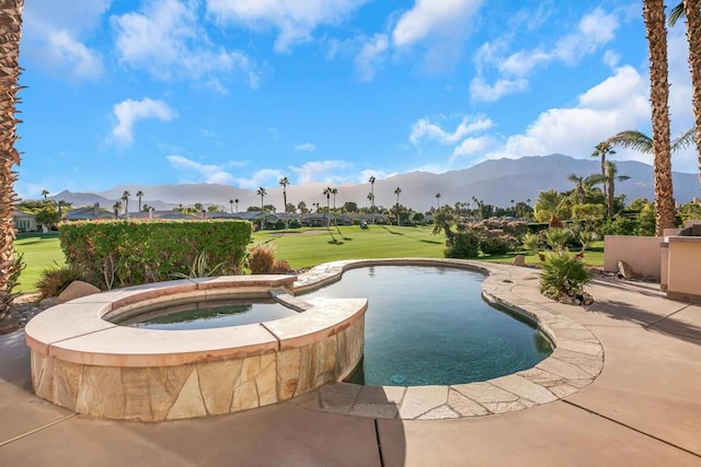 view of pool with a lawn, a mountain view, and an in ground hot tub