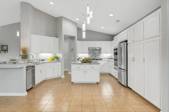 kitchen with white cabinetry, a kitchen island, light tile patterned flooring, and appliances with stainless steel finishes