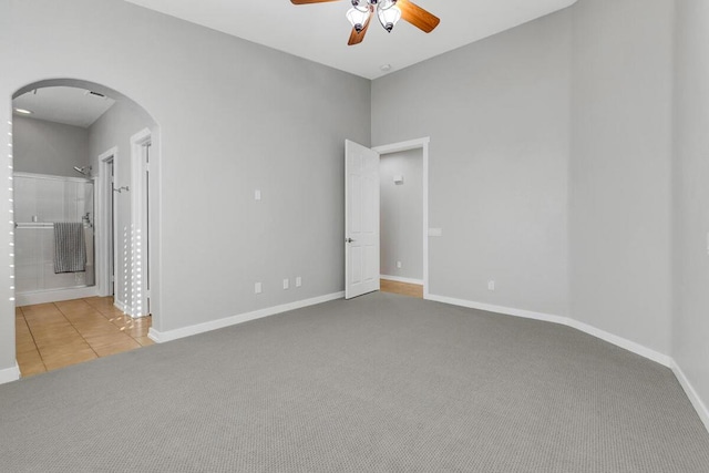 carpeted spare room with ceiling fan