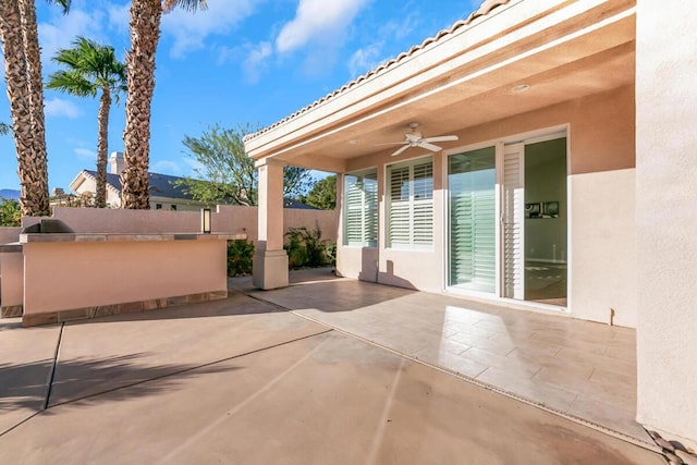 view of patio / terrace featuring ceiling fan and an outdoor kitchen