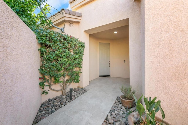 view of exterior entry featuring a patio