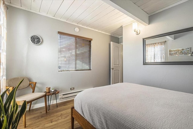 bedroom featuring beamed ceiling, a baseboard radiator, hardwood / wood-style flooring, and wooden ceiling