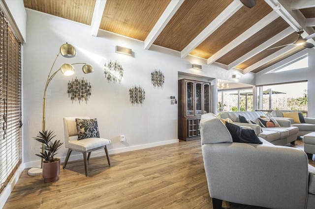 living room with beam ceiling, hardwood / wood-style flooring, and high vaulted ceiling