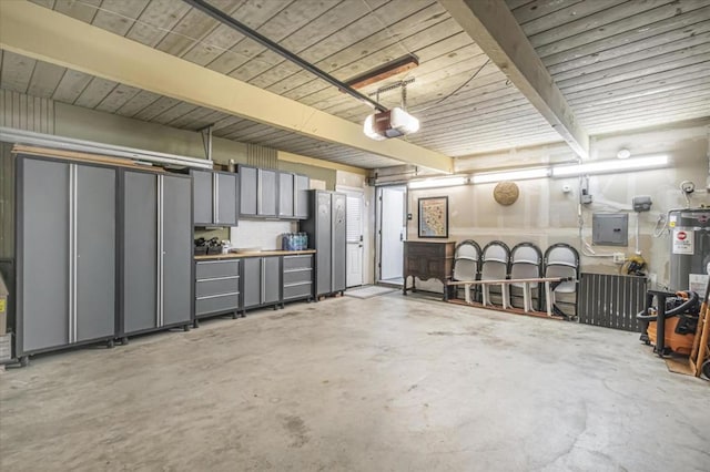 garage featuring a garage door opener, electric panel, and stainless steel refrigerator