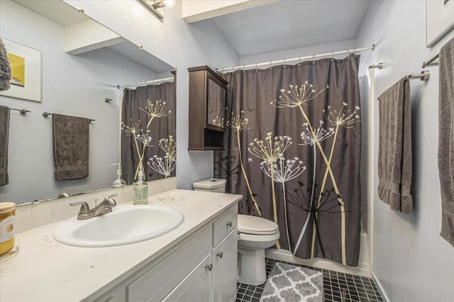 bathroom with tile patterned floors, vanity, and toilet