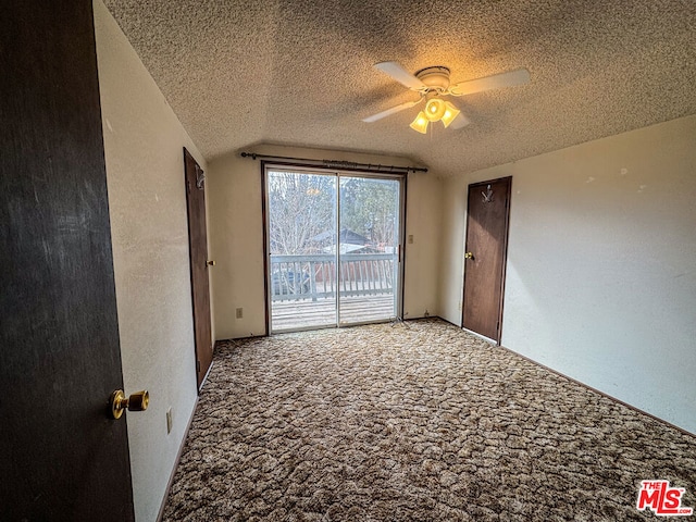 spare room with carpet flooring, a textured ceiling, ceiling fan, and lofted ceiling