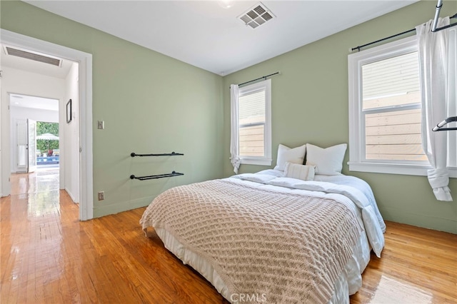 bedroom featuring light hardwood / wood-style flooring and multiple windows