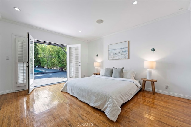 bedroom featuring access to exterior, wood-type flooring, a closet, and ornamental molding