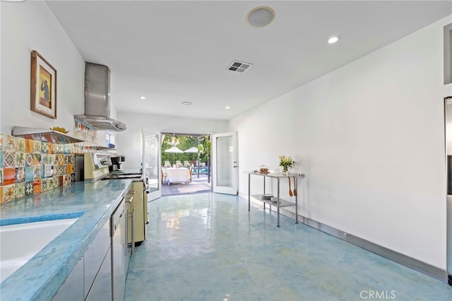 kitchen featuring range, sink, and wall chimney range hood