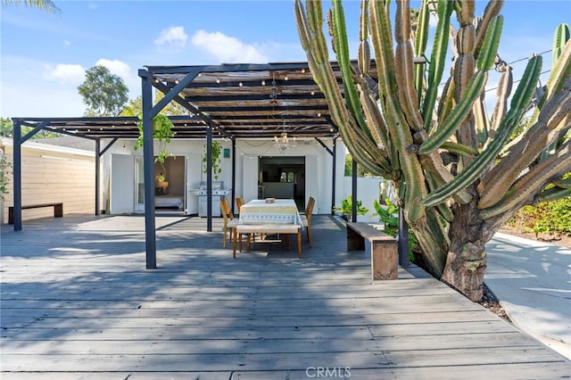 wooden deck with a pergola and grilling area