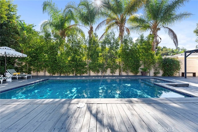 view of swimming pool featuring a deck