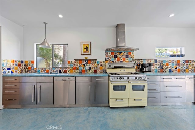 kitchen featuring tasteful backsplash, white appliances, wall chimney range hood, pendant lighting, and carpet floors