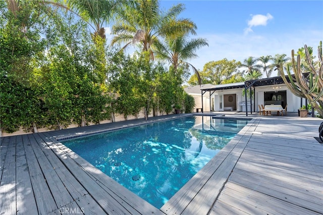 view of swimming pool with a wooden deck