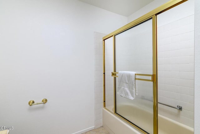 bathroom featuring combined bath / shower with glass door