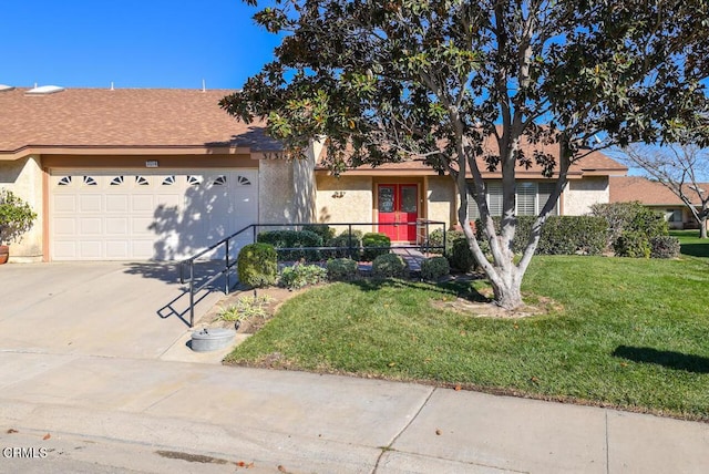 single story home with a front yard and a garage