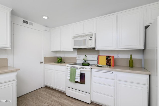 kitchen featuring white appliances, light hardwood / wood-style floors, and white cabinetry