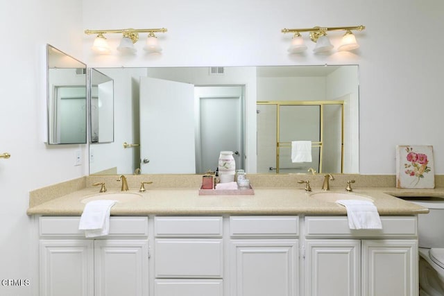 bathroom with vanity, toilet, and walk in shower