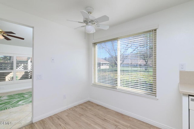 unfurnished dining area with light wood-type flooring, a wealth of natural light, and ceiling fan