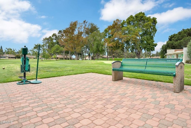 view of home's community featuring a lawn and a patio