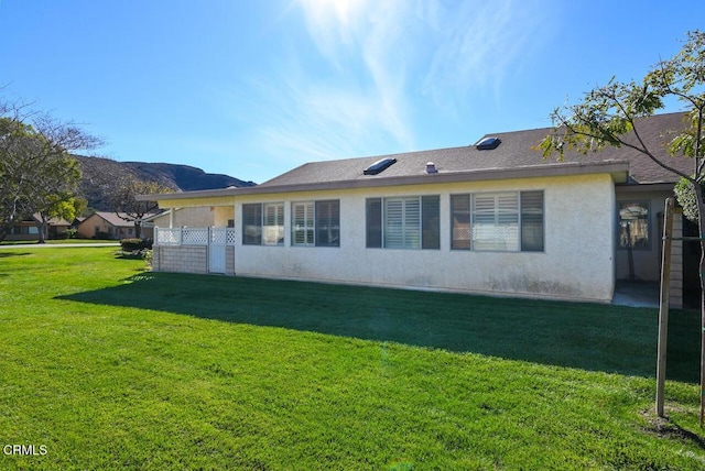 rear view of house with a yard