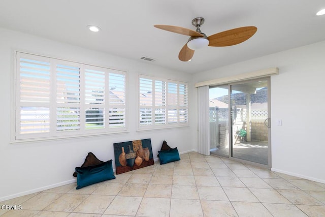 interior space with ceiling fan