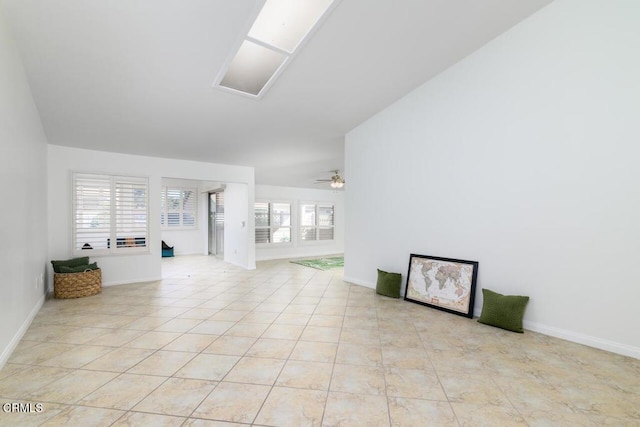 unfurnished living room with ceiling fan, a healthy amount of sunlight, and light tile patterned flooring