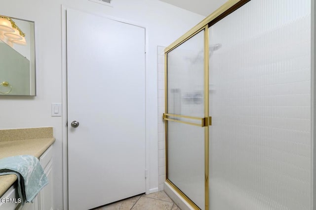 bathroom featuring tile patterned floors, vanity, and an enclosed shower