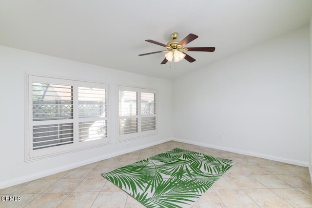 tiled spare room featuring ceiling fan