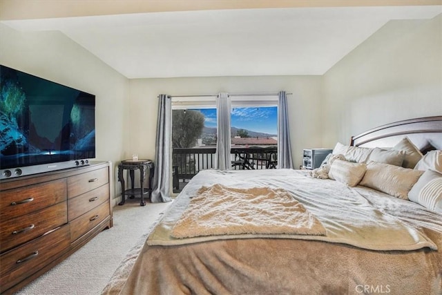 bedroom with access to exterior, lofted ceiling, and light carpet