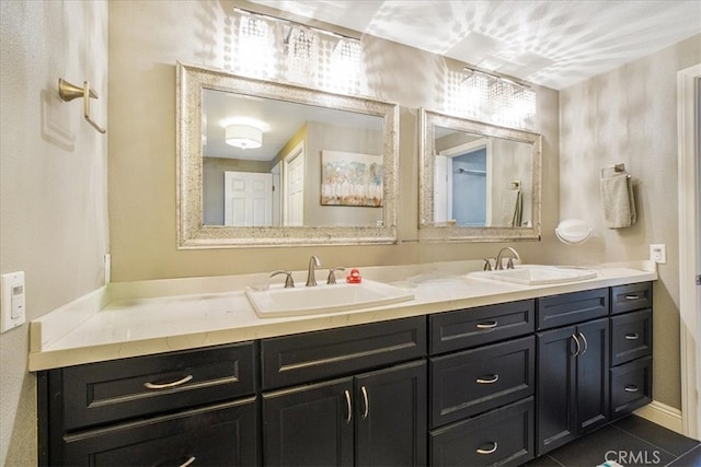 bathroom featuring tile patterned flooring and vanity