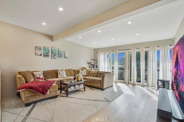 living room featuring light hardwood / wood-style floors and beamed ceiling