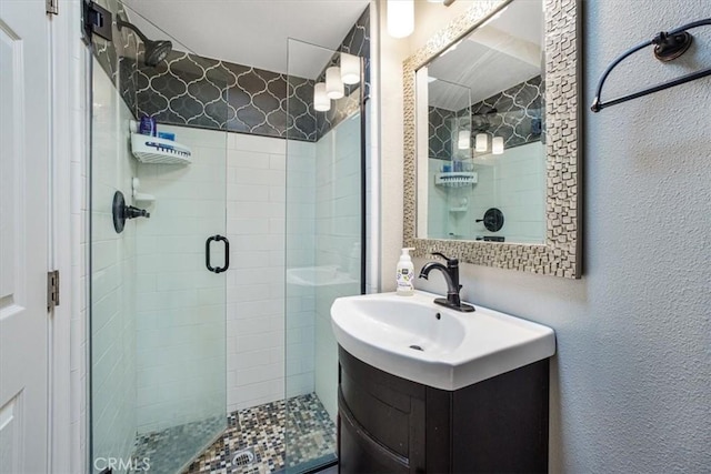 bathroom featuring walk in shower and vanity