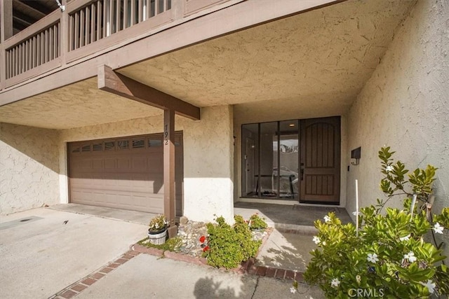 doorway to property featuring a garage and a balcony