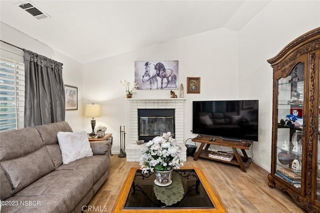 710 Crystal Way, Nipomo, CA 93444 - living area with vaulted ceiling, light wood finished floors, and a brick fireplace