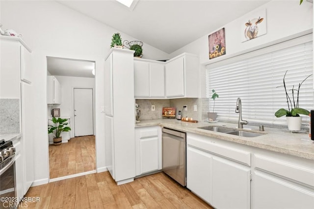 710 Crystal Way, Nipomo, CA 93444 - kitchen with stainless steel appliances, vaulted ceiling, light wood-style flooring, light countertops, and white cabinets