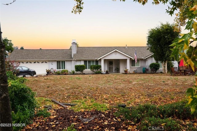 710 Crystal Way, Nipomo, CA 93444 - ranch-style house featuring an attached garage, a chimney, and stucco siding