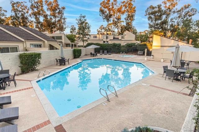 view of swimming pool featuring a patio area and a community hot tub