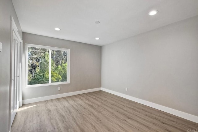 spare room with light hardwood / wood-style floors