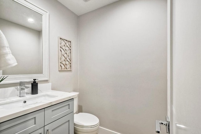 bathroom with toilet and vanity