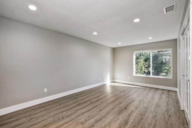 unfurnished room featuring hardwood / wood-style flooring