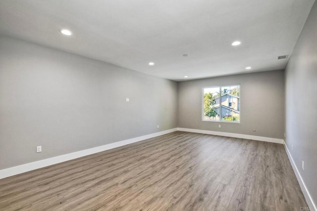 spare room with light hardwood / wood-style floors