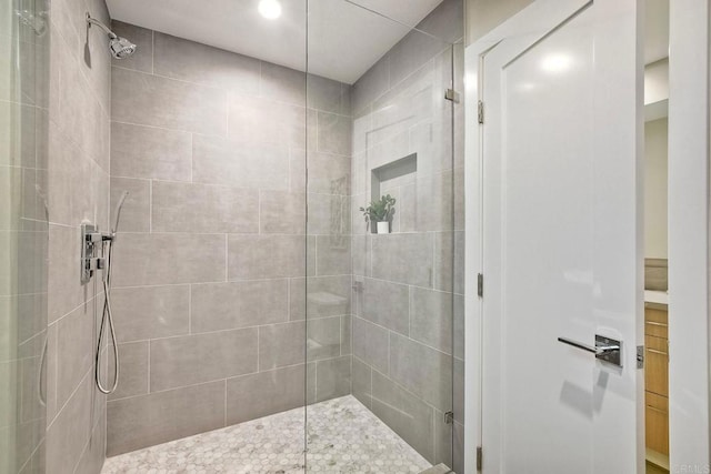 bathroom featuring vanity and tiled shower