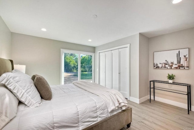 bedroom with a closet, light hardwood / wood-style flooring, and access to outside