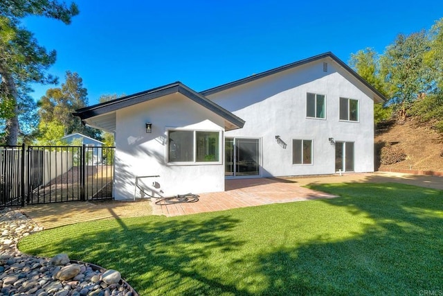 rear view of house with a patio area and a yard