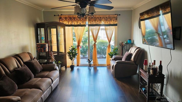 living room featuring dark hardwood / wood-style flooring, ceiling fan, and crown molding