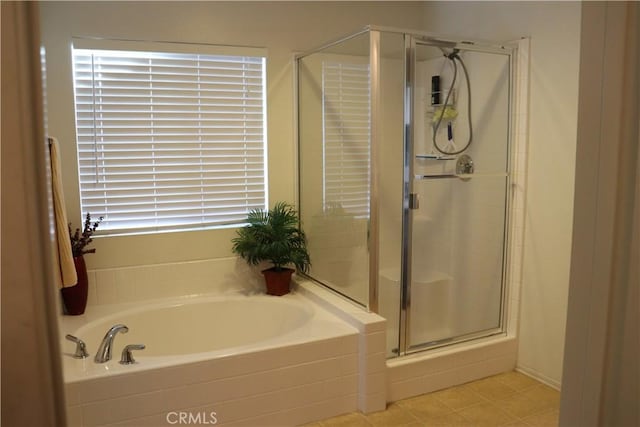 bathroom featuring shower with separate bathtub