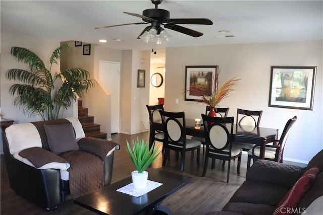 living room with ceiling fan and dark wood-type flooring