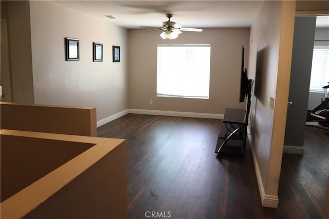 spare room featuring ceiling fan and dark wood-type flooring