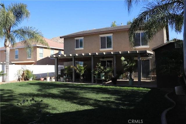 rear view of house featuring a lawn