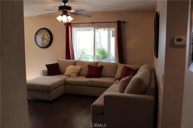 living room with ceiling fan and dark wood-type flooring